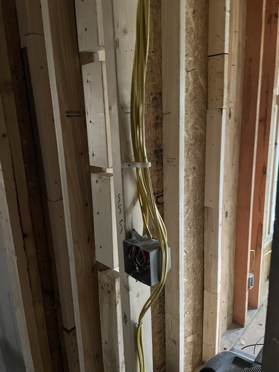Residential electrical cable routing through wall framing