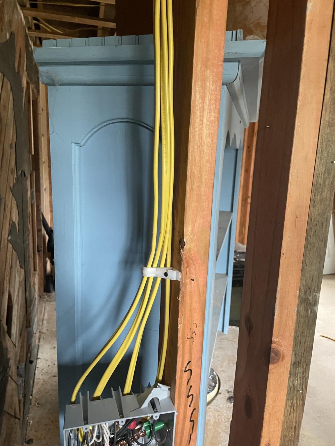 New residential branch circuit wiring routed through exposed wall framing