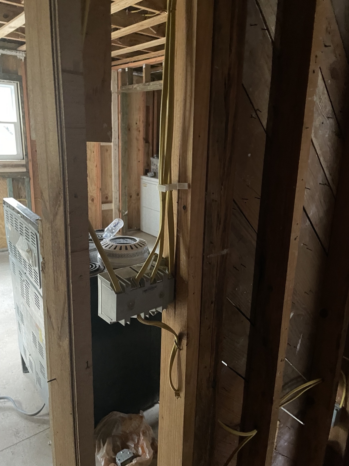 Electrical wiring routed to a device box in exposed framing