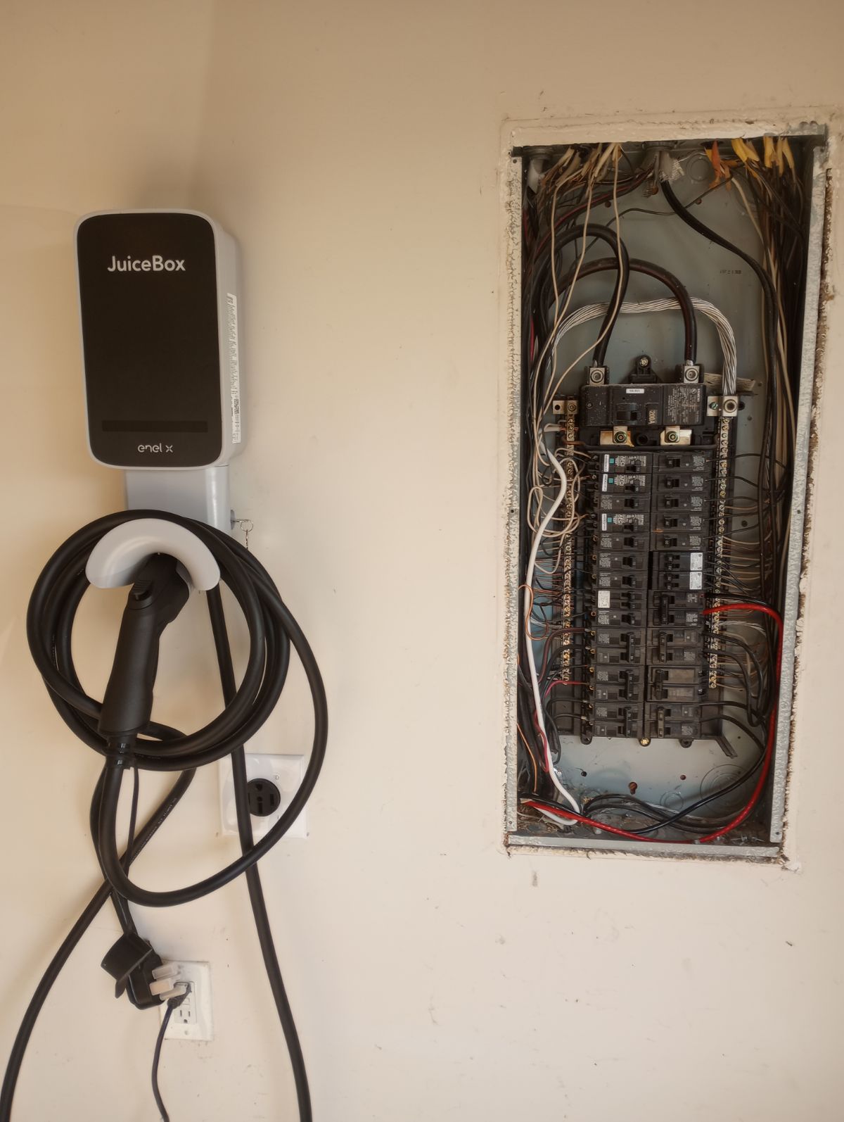 JuiceBox EV charger beside electrical panel