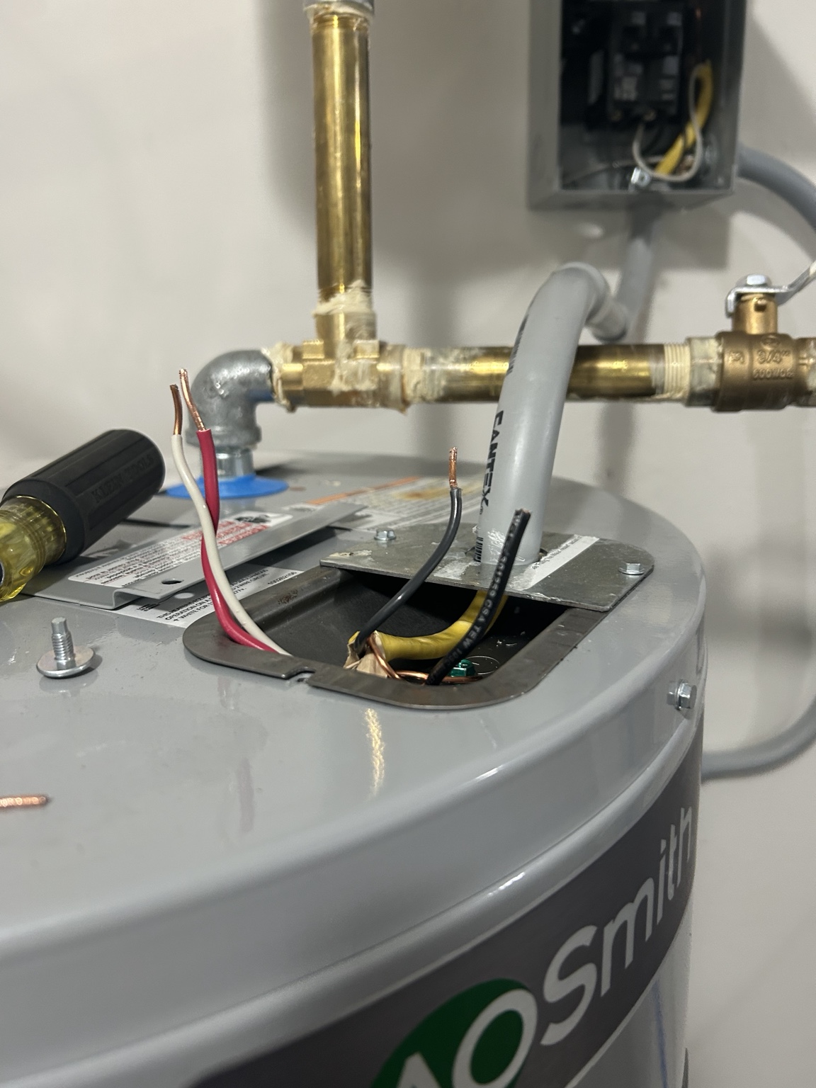 Water heater circuit wiring being repaired by electrician