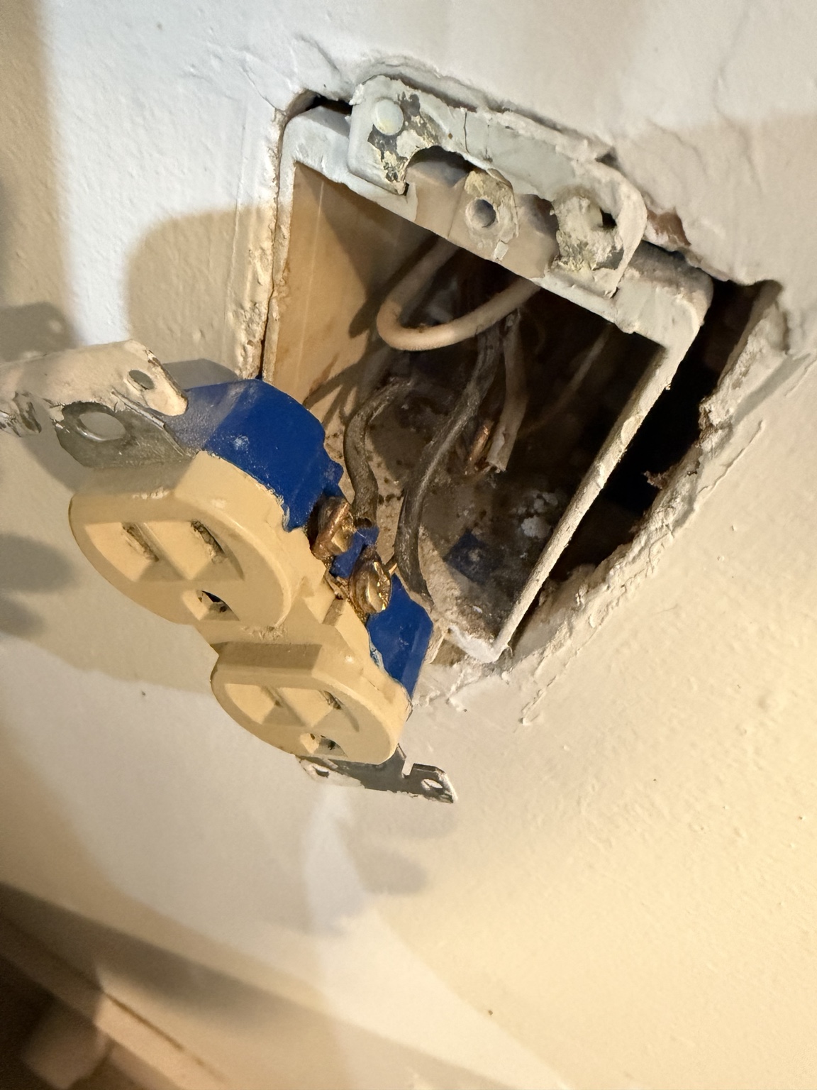 Electrical receptacle removed for inspection and repair